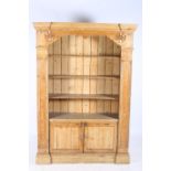 A 19TH CENTURY PINE OPEN FRONT DRESSER the breakfront cornice above four open shelves between