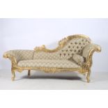 A CONTINENTAL GILTWOOD AND UPHOLSTERED SETTEE the carved top rail with button upholstered back and