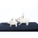 TWO GLAZED CHINA FIGURES modelled as flying pigs