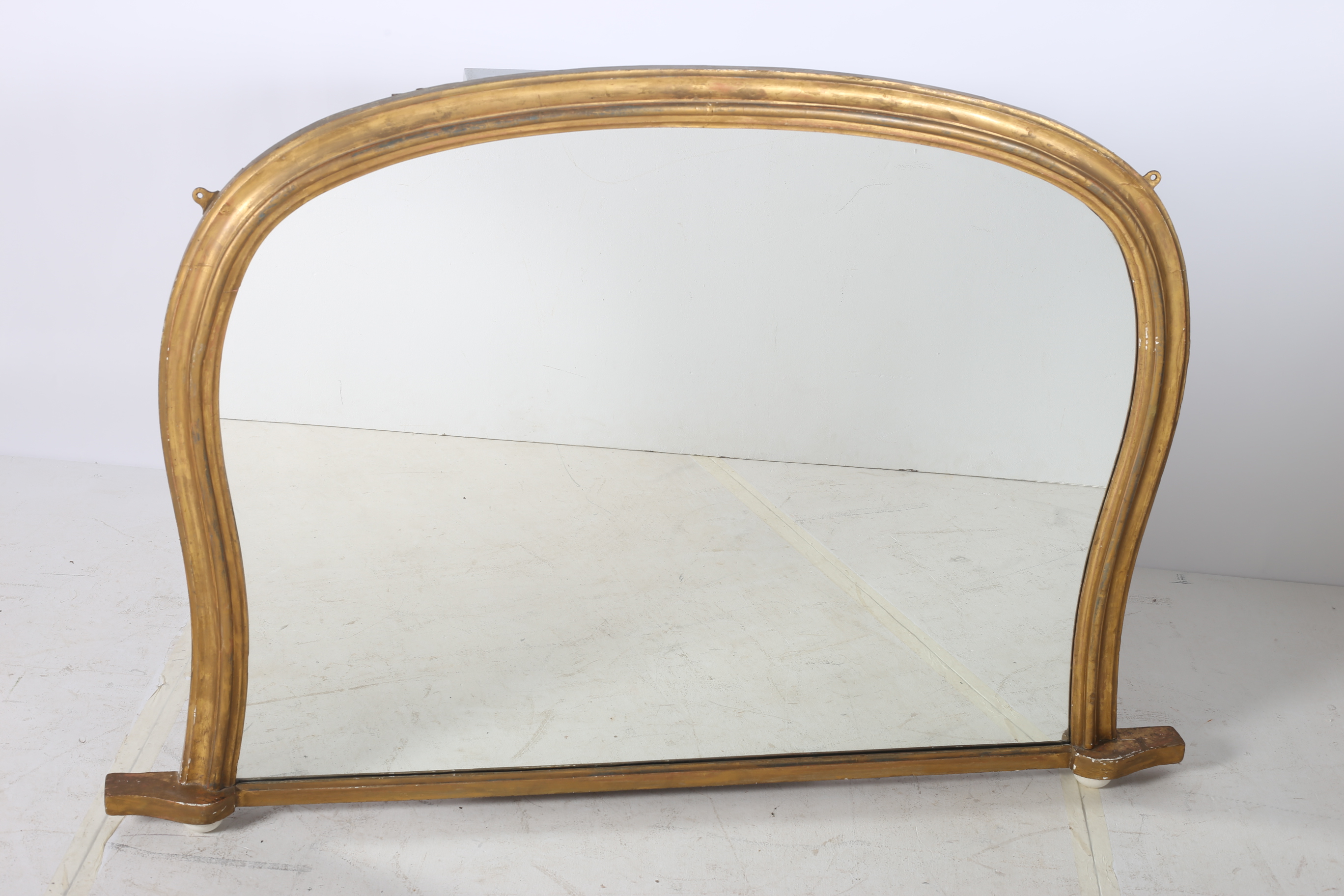 A 19TH CENTURY GILTWOOD OVERMANTEL MIRROR the shaped plate within a moulded frame raised on