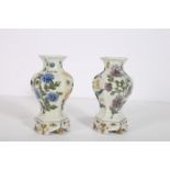 A PAIR OF CONTINENTAL PORCELAIN VASES each of octagonal shaped form the white ground decorated with