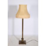 A BRASS CORINTHIAN COLUMN FLOOR STANDARD LAMP the reeded column above a square stepped base with