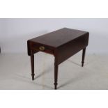 A 19TH CENTURY MAHOGANY DROP LEAF TABLE the rectangular hinged top with frieze drawer on faceted