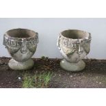 A PAIR OF COMPOSITION SANDSTONE URNS each of circular tapering form with Greek key decoration on