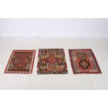 THREE AFGHAN WOOL KILIMS each with a multicoloured ground decorated with palmettes hooks and