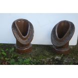 A PAIR OF GLAZED TERRACOTTA CHIMNEY COWLS each of oval tapering form with circular collar 43cm (h)