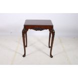 A CHIPPENDALE DESIGN CARVED MAHOGANY TABLE the rectangular top with canted angles above a shell of