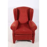 A GOOD UPHOLSTERED WING CHAIR with scroll over arms and loose cushion