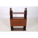 AN ARTS AND CRAFTS OAK CABINET the superstructure with open shelves above a hinged cupboard and