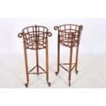 A PAIR OF WROUGHT IRON JARDINIERE STANDS each of circular form with openwork frieze raised on