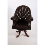 A GOOD HIDE UPHOLSTERED BUTTON BACK SWIVEL OFFICE CHAIR with scroll over arms on revolving base