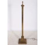 A BRASS CORINTHIAN COLUMN FLOOR STANDARD LAMP with reeded column above a square stepped base 146cm