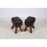 A PAIR OF RETRO HIDE UPHOLSTERED AND HARDWOOD STOOLS each of rectangular form with panelled seats