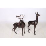 A PAIR OF BRONZE FIGURES modelled as a deer and fawn each shown standing one with head raised the