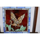 A STAINED GLASS AND LEAD GLASS PANEL depicting a bird 22cm x 32cm