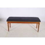 A VICTORIAN DESIGN MAHOGANY AND UPHOLSTERED STOOL the rectangular seat above a panelled frieze on