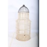 A WHITE PAINTED AND METAL BIRD CAGE of cylindrical form with domed hood 155cm (h) x 70cm (d)