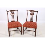 A PAIR OF CHIPPENDALE DESIGN MAHOGANY SIDE CHAIRS each with a serpentine top rail above a pierced