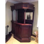 A MAHOGANY BAR UNIT with back panel and mirror and cornice the shaped moulded counter top with