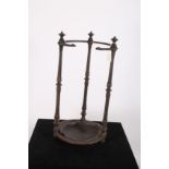 A CAST IRON STICK STAND of circular form with reeded uprights and foliate decoration 60cm x 30cm