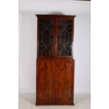 A GEORGIAN MAHOGANY LIBRARY BOOKCASE on associated base the moulded cornice above a pair of