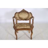 A CONTINENTAL HARDWOOD PARCEL GILT AND UPHOLSTERED SALON CHAIR the shaped top rail with pierced and