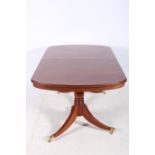 A GEORGIAN DESIGN MAHOGANY INLAID DINING TABLE of rectangular outline the shaped top with rounded