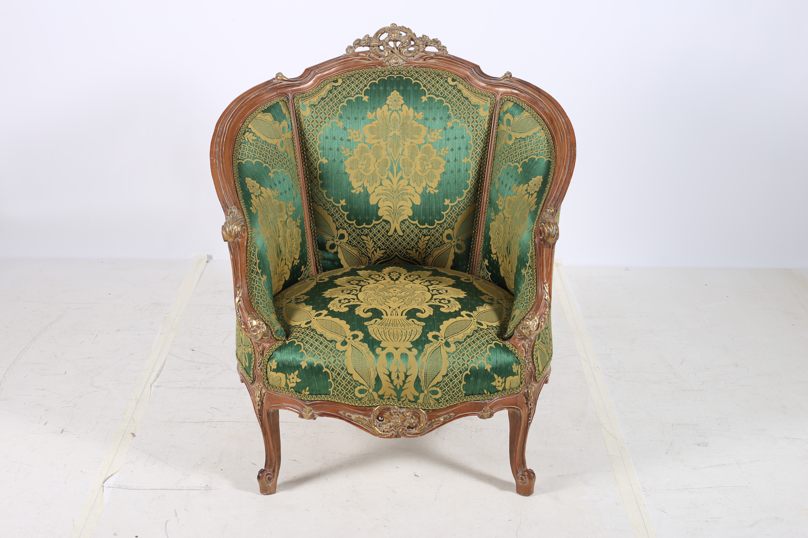 A CONTINENTAL WALNUT AND PARCEL TUB SHAPED CHAIR the pierced carved top rail above an upholstered