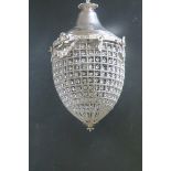 A CONTINENTAL SILVERED AND CUT GLASS BASKET CHANDELIER of cylindrical tapering form hung with