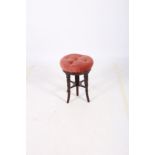 A 19TH CENTURY MAHOGANY REVOLVING STOOL the circular button upholstered seat on ring turned