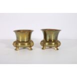 A PAIR OF ORIENTAL BRASS JARDINIERES each of circular shaped form raised on mask claw feet 21cm (h)