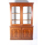 A VICTORIAN MAHOGANY LIBRARY BOOKCASE the outset moulded cornice above a pair of glazed doors