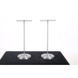 A PAIR OF WHITE METAL HAT STANDS each raised on a circular foot 48cm (h) x 18cm (d)