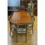 A REGENCY DESIGN MAHOGANY ELEVEN PIECE DINING SUITE comprising ten chairs including a pair of elbow