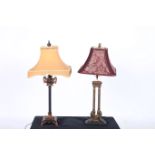 TWO CONTINENTAL EBONISED AND GILT DECORATED TABLE LAMPS with shades 79cm (h)