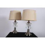 A PAIR OF CONTINENTAL WHITE METAL AND CUT GLASS TABLE LAMPS each of urn form with faceted