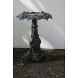 A CAST IRON TABLE the circular top cast with flower heads and foliage above a triform base with