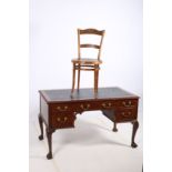 A GOOD CHIPPENDALE DESIGN MAHOGANY DESK of rectangular outline the shaped top with tooled leather