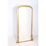 A 19TH CENTURY GILTWOOD AND GESSO MIRROR the rectangular arched plate within a moulded frame with