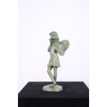 A BRONZED GREEN PATINATED FIGURE modelled as an angel shown standing blowing a pipe raised on a