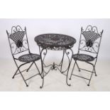 A TWO PIECE WROUGHT IRON PATIO SUITE comprising pair of folding chairs each with a lattice work and