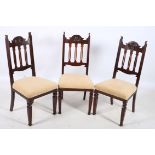 A GOOD SET OF ARTS AND CRAFTS MAHOGANY DINING CHAIRS each with a shaped top rail with carved panel