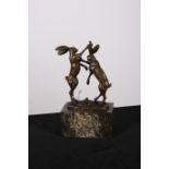 AFTER NICK A BRONZE GROUP modelled as two hares shown fighting standing on hind legs on a