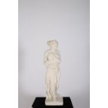 A COMPOSITION STONE FIGURE modelled as a classical semi-clad linen draped female shown standing on