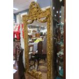 A CONTINENTAL GILTWOOD AND GESSO MIRROR the rectangular bevelled glass plate within an acanthus