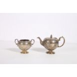 A SILVER EMBOSSED TEA POT with scroll handle on circular foot Edinburgh 1848 16 troy oz together
