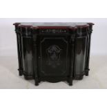 A CONTINENTAL EBONISED SIDE CABINET of serpentine outline the shaped top with frieze drawer and