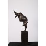 A BRONZE FIGURE modelled as an acrobat doing a handstand raised on rectangular pedestal 48cm (h)