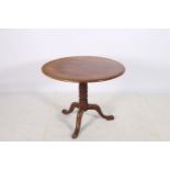 A 19TH CENTURY MAHOGANY POD TABLE the circular top above a turned column on tripod support with pad