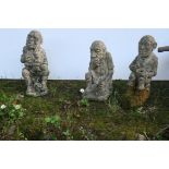 THREE COMPOSITION STONE FIGURES modelled as gnomes each shown seated 33cm (h)